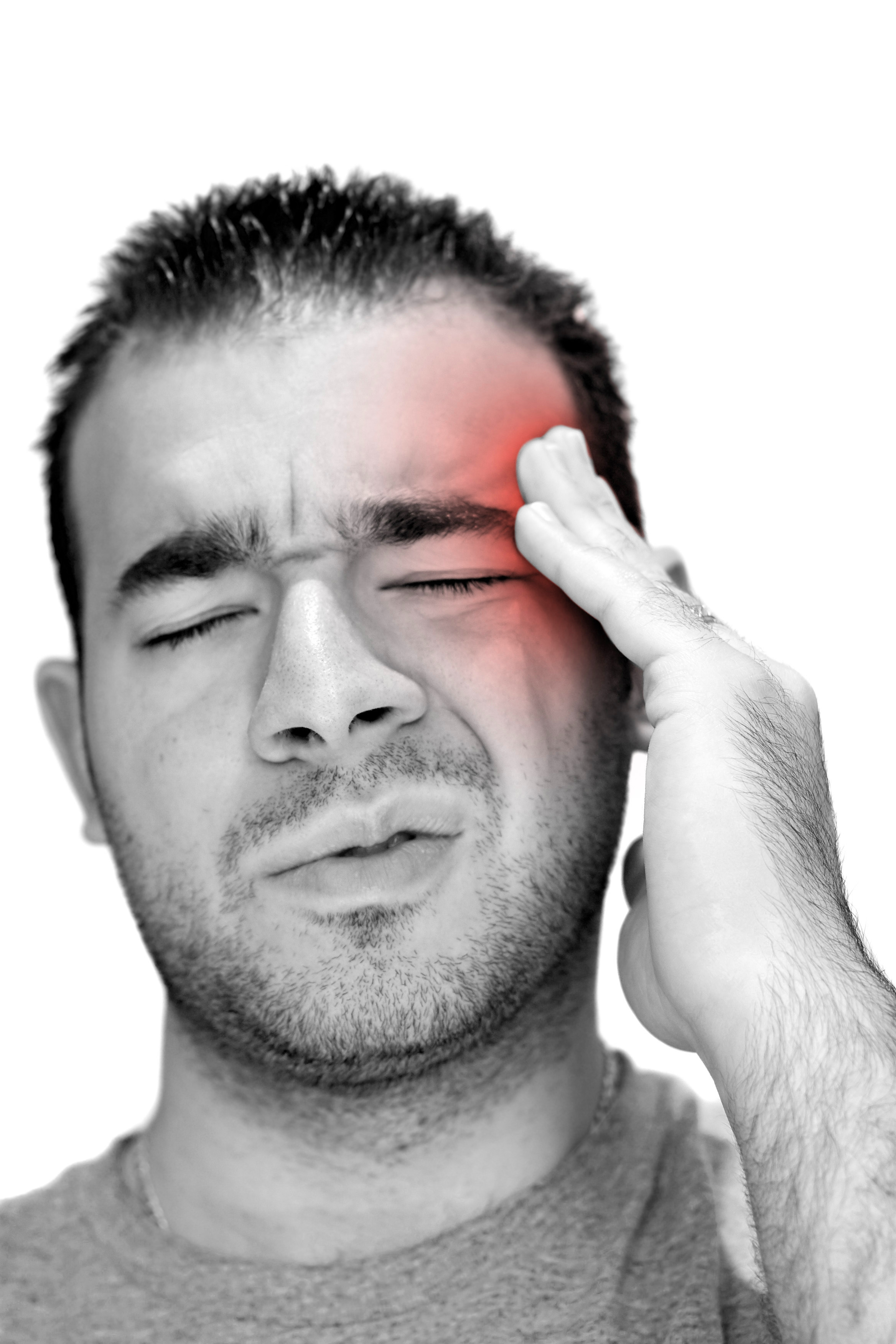 a young man grasps his head in anguish from pain or even stress rK1lSutAro