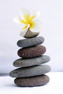rock stack with white flower on top
